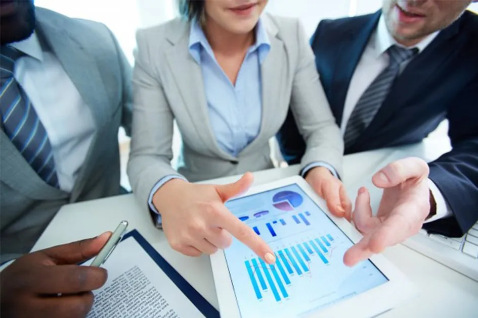 Colleagues looking at a chart on a tablet